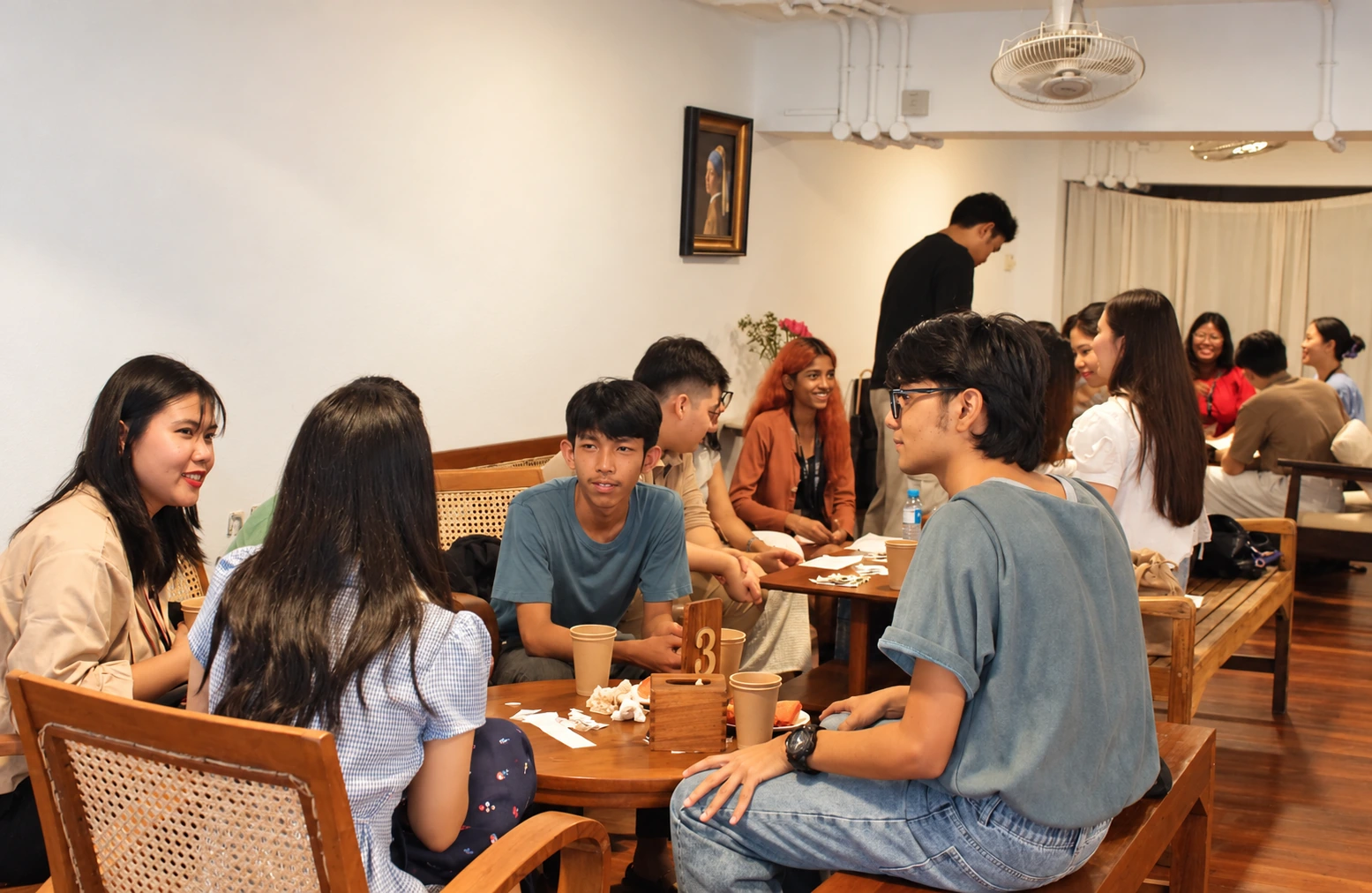 Students practising English conversation in small groups